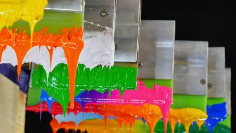 white,orange and yellow ink are hang on handle printer.
tee shirt factory always use plastisol ink to print on tee shirt.
studio shot.beautiful colors background.dripping colorful paint.
