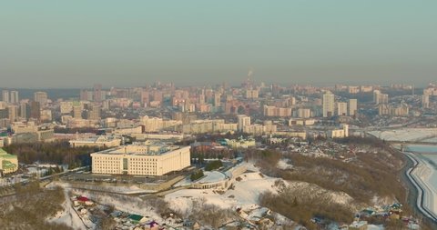 Government house Republic of Bashkortostan. The building of the city administration of Ufa on the mountain and the background of the city at winter sunset. Aerial drone view