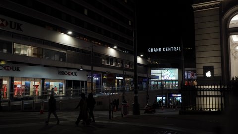 BIRMINGHAM, UK - 2022: Birmingham city centre at night with people and Grand Central Station