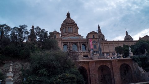 Barcelona, Spain - 01-19-2018: Palacio Nacional de Montjuic cloudy day, tourists visiting landmark, museum, time lapse cloudy day