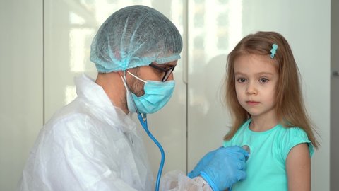 Doctor pediatrician uses stethoscope listen heart of child girl patient. Lung breathing check. Medicine and healthcare concept.