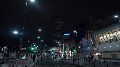 BIRMINGHAM, UK - 2022: Birmingham city centre streets and Bullring tower building with people at night