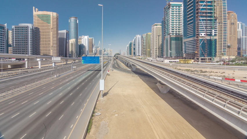 Amazing top view on Sheikh Zayed road surrounded Dubai Marina and JLT skyscrapers from bridge, Dubai. Traffic on highway and metro line. United Arab Emirates