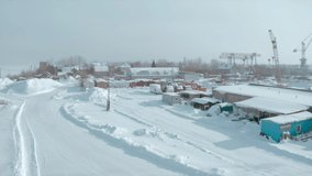 Bird's-eye view of the winter city.Clip. White background where a small village with small houses is visible and a large frozen pond is visible.