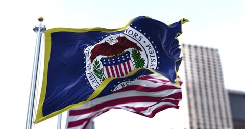 Washington D.C., USA, March 2022: The flag of the American Federal Reserve System waving in the wind with the flag of the United States blurred in the background. 
