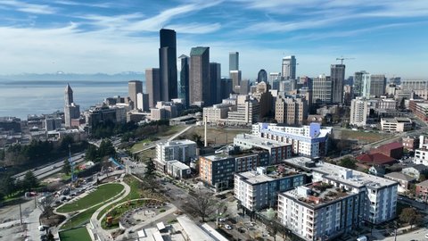 Cinematic 4K aerial drone trucking shot of First Hill, Yesler Terrace, Atlantic, Cherry Hill, Squire Park, skyscrapers and high-rise buildings downtown Seattle, Washington