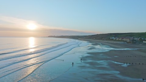 Sandsend, Whitby, North Yorkshire Coast aerial droneement from sea towards sea and dog walkers. Early morning , March 2022. DJI Mavic 3 Prores Clip2