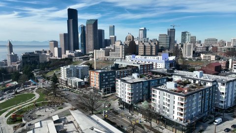 Cinematic 4K aerial drone rise and reverse shot of First Hill, Yesler Terrace, Atlantic, Cherry Hill, Squire Park, skyscrapers and high-rise buildings downtown Seattle, Washington