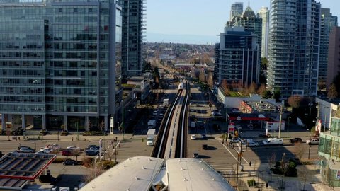 Burnaby , BC , Canada - 01 10 2022: Metro Vancouver Skytrain On Railway Approaching Station