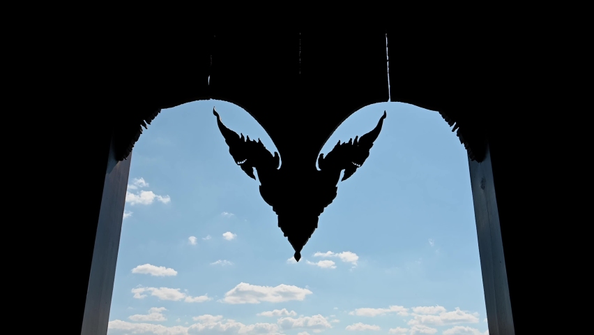 Time lapse of the clouds and the blue sky taken trough the Door of Wat Somdet in Phu Ruea, Ming Mueang, Loei in Thailand.