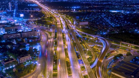 Road traffic transportation timelapse. Road and Roundabout, multilevel junction motorway, multiple roads in city, vehicular intersection, expressway with important infrastructure time lapse.