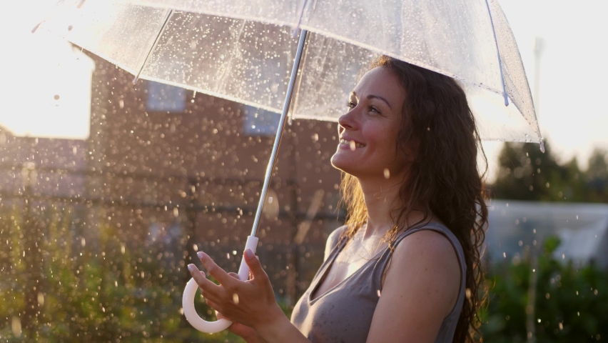 Happy young woman enjoying and having fun with umbrella outdoor at sunny weather. slow motion | Shutterstock HD Video #1088452305