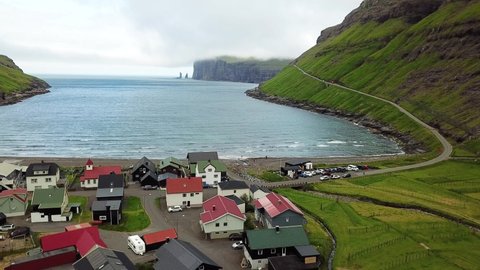 Denmark. Faroe islands. Breathtaking nature of The Faroe Islands, a self-governing archipelago, part of the Kingdom of Denmark. Wild Shoreline aerial view. Aerial view of stunning coast in cloudy