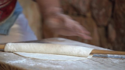  Professional female hands rolling dough. Woman' s hands rolling dough for preparing bread, cake, pizza or else.  Armenian  bread (Lavash, Pita, Flatbread ) preparing process.