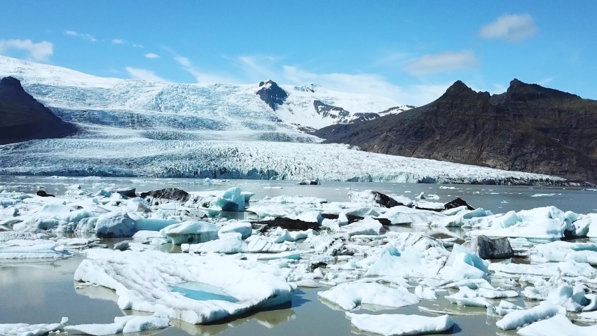 Global warming and climate change. Melting glacier in Iceland. Icebergs melt at turquoise ocean bay. Huge ice glacier at polar nature environment. Arctic winter landscape at global warming problem Royalty-Free Stock Footage #1088455709