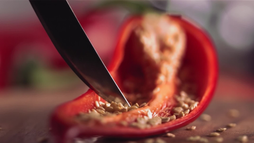 Slow Motion of Grains from Red Chilli Pepper with Knife Royalty-Free Stock Footage #1088456933