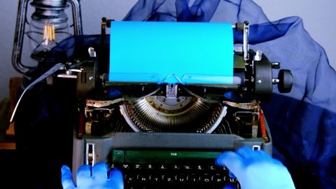 female hands in gloves press keyboard of an old typewriter, vintage lantern shines, secretary typing text on blue paper, concept of old fashioned blogger, writer, detective, blank mockup for designer