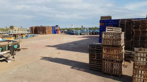 Stacks of fruits and vegetable crates in storehouse