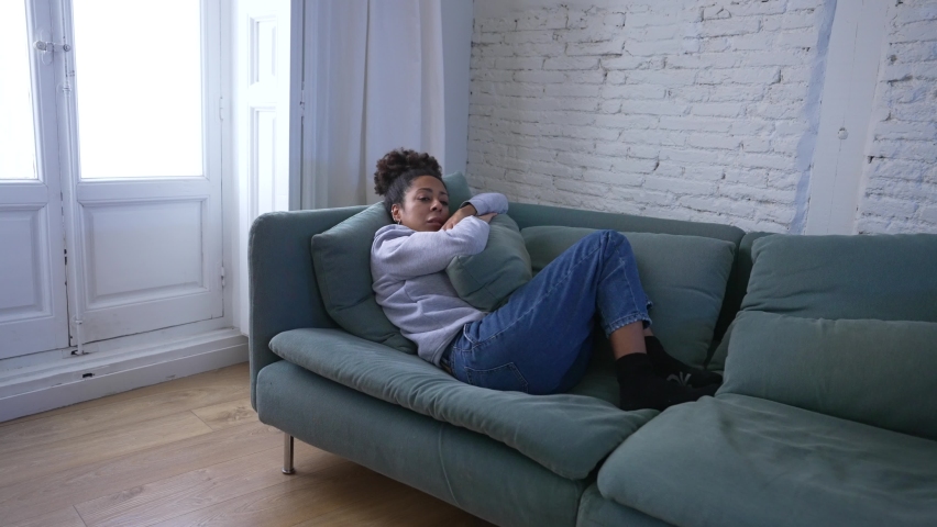 Lonely young African  American young woman suffering from depression, exhausted, worried and desperate at home. In Mental health concept. | Shutterstock HD Video #1088461333
