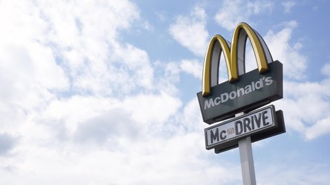 Krakow, Malopolska, Poland - February 2022: McDonald's Mc Drive brand logo sign, signage detail closeup, cloudy sky background McDonalds company restaurant business symbol up close, McD emblem, nobody