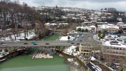 Kutaisi, Georgia - March 18, 2022: Aerial view on traffic on bridges and Shota Rustaveli avenue.
