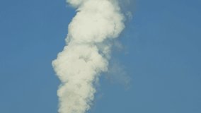 White smoke against blue sky. Video 4k resolution. Pollution of environment. Gas emission into atmosphere. Environmental problem and catastrophe. Clouds of smoke in clear sky.