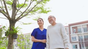 Asian young caregiver nurse support senior older male walking outdoors. Specialist girl doctor help and take care of elderly mature man patient doing physical therapy in public park at nursing home. - Powered by Shutterstock - Get 15% off with code: PIKWIZARD15