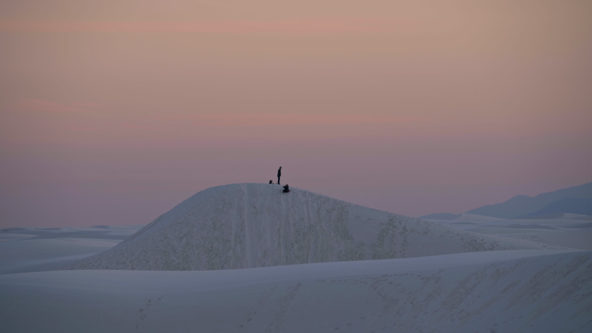 Family plays on white sands national park dunes during beautiful sunset, 4K