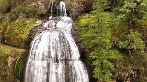 Silver Falls Oregon Coos County waterfall in slow motion, drone descending shot.