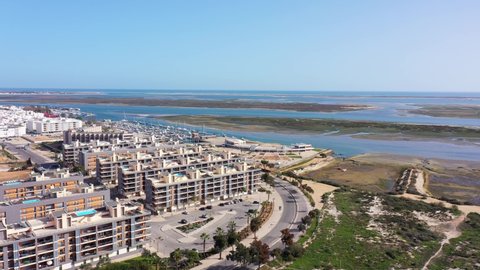 Aerial view of the urban area of portugal houses with modern infrastructure swimming pools overlooking the sea. Portugal's southern city of Olhao Ria Formosa