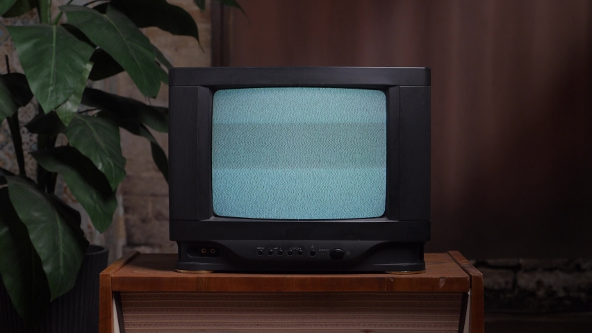 Home interior old television set. Bad television signal noise. Living room old tv set. 90s retro tv screen static noise. Analog static effect retro tv room interior. Television in retro interior home.