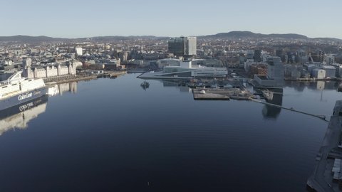 In the harbor of the Oslo fjord by aker brygge and the Opera House. 4k Drone footage during sunrise over the Oslo harbor. 