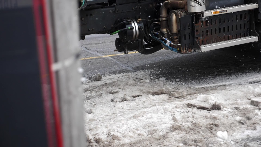 Truck mounted salter applying salt to snowy street. Slow motion. Toronto, Ontario, Canada. Royalty-Free Stock Footage #1088480463