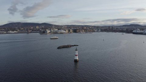 The Oslo fjord and harbor around aker brygge during sunrise. See the spectacular Oslo landmark with 4k drone video. Oslo city skyline visible in the background. 