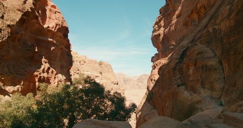 PETRA - Jordan's most-visited tourist attraction. Historic and archaeological Red Rose City with Scenic Gorge or Canyon and rock-cut structures carved into a stone cliff. 4K panoramic gimbal shot