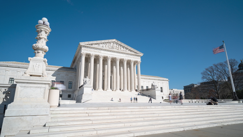 Washington DC- March 19th, 2022:  A 4k time lapse of people at the Supreme Court in Washington DC on a clear day.