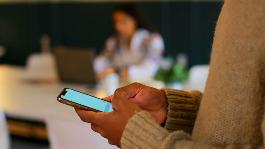 Animation of stains over biracial businesswoman using smartphone. social media and communication interface concept digitally generated video.