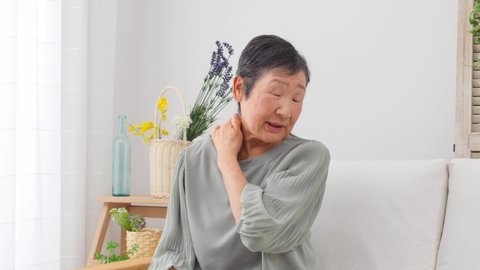 Asian senior woman having stiff shoulders