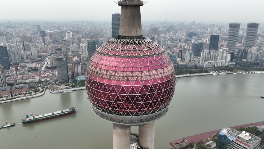 Drone aerial view of Oriental Pearl Tower and downtown Shanghai China. Business, landmark and travel concept b-roll footage. Buildings around Huangpu River. Cityscape and city life 4k video