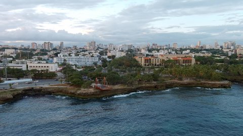 Jagged and rocky coast along Malecon of Santo Domingo in Dominican Republic. Aerial sideways