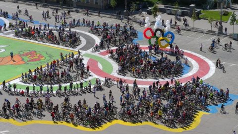 KHARKIV, UKRAINE - MAY 23, 2021: Mass people rides on bikes in city street. Leisure and lifestyle concept. Bicycle marathon in springtime. Race competition event for cyclists. Citizens with bicycles