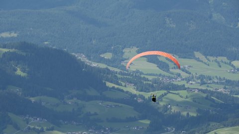 Parasailer soars over Austrian Valley below