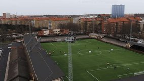 People training on Malmo soccer field, Sweden. Aerial drone view