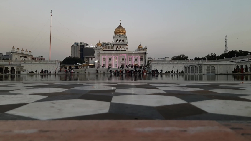 Gurdwara Bangla Sahib is the most prominent Sikh Gurudwara, Bangla Sahib Gurudwara inside view during evening time in New Delhi, India, Sikh Community one of the famous gurudwara Bangla Sahib view | Shutterstock HD Video #1088487127
