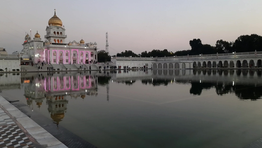 Gurdwara Bangla Sahib is the most prominent Sikh Gurudwara, Bangla Sahib Gurudwara inside view during evening time in New Delhi, India, Sikh Community one of the famous gurudwara Bangla Sahib view | Shutterstock HD Video #1088487129