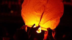 sky lantern being held by tourists closeup  in Saint John bonfires in Coruna  Galicia, feast of  international Tourist Interest , video hd footage