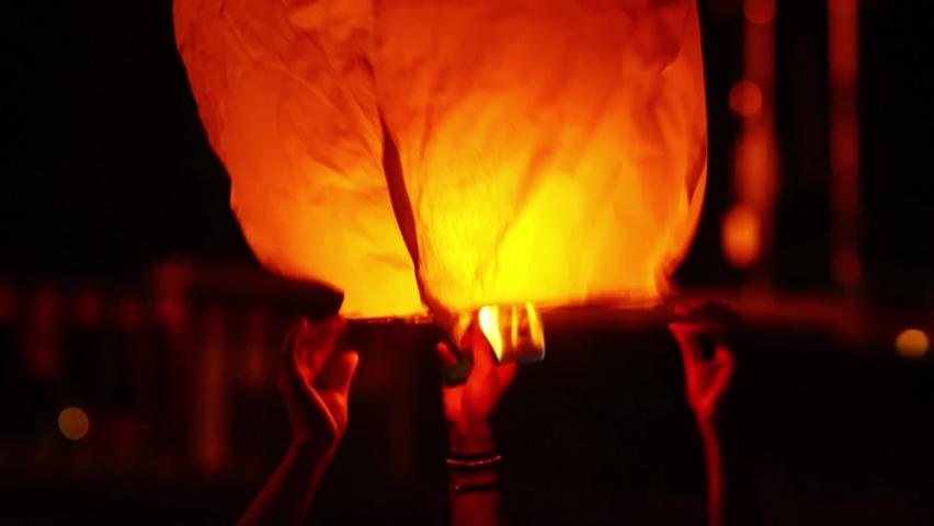 sky lantern being held by tourists closeup  in Saint John bonfires in Coruna  Galicia, feast of  international Tourist Interest , video hd footage