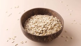 Slow Motion of Rolled Oats Falling In Coconut Bowl. Clean Eating, Dieting, Fiber Concept - Powered by Shutterstock - Get 15% off with code: PIKWIZARD15