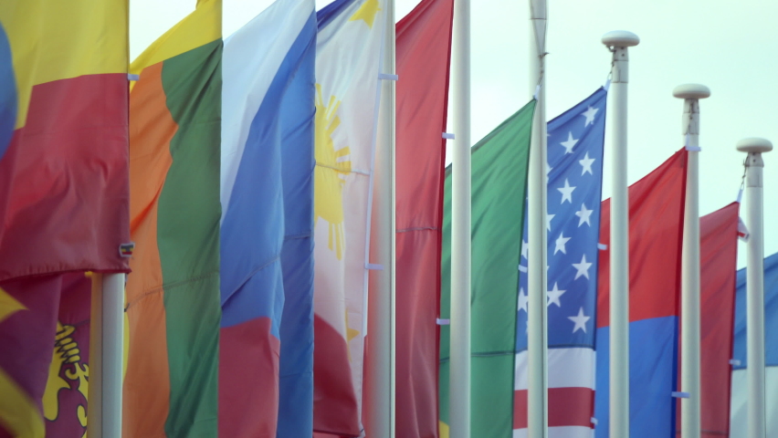 Flags of different countries of the world flutter in the wind against the sky. Royalty-Free Stock Footage #1088493105