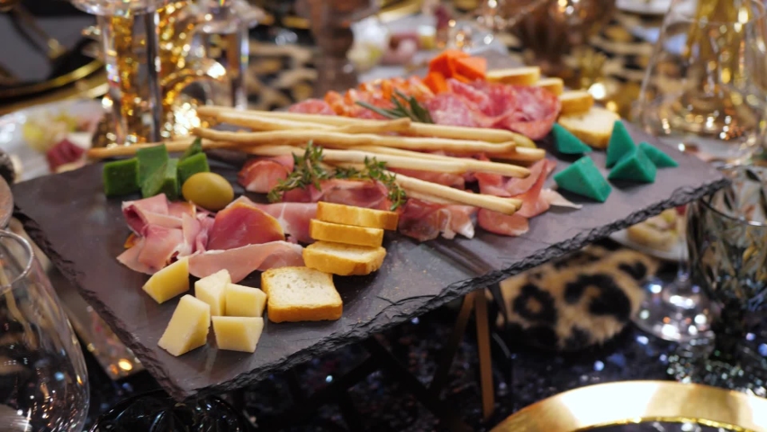 Luxurious decorated banquet table with various appetizers for corporate Christmas party or birthday or wedding celebration, close up | Shutterstock HD Video #1088493815